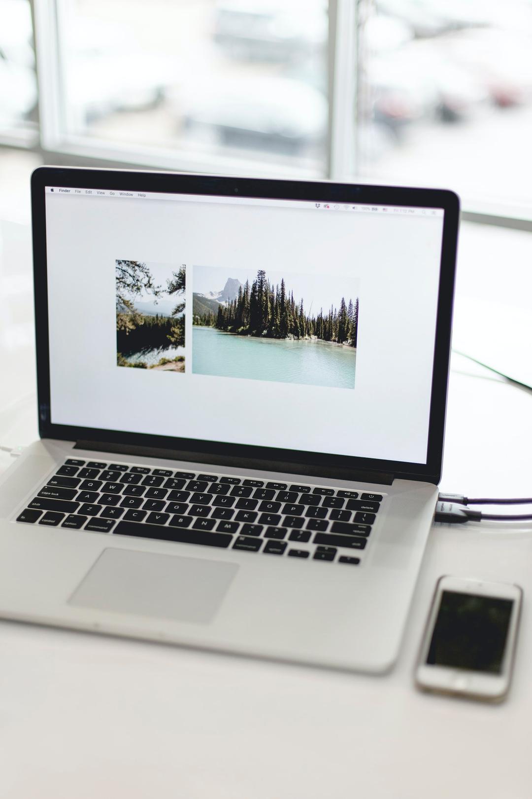 Laptop on desk with a 2 photo website